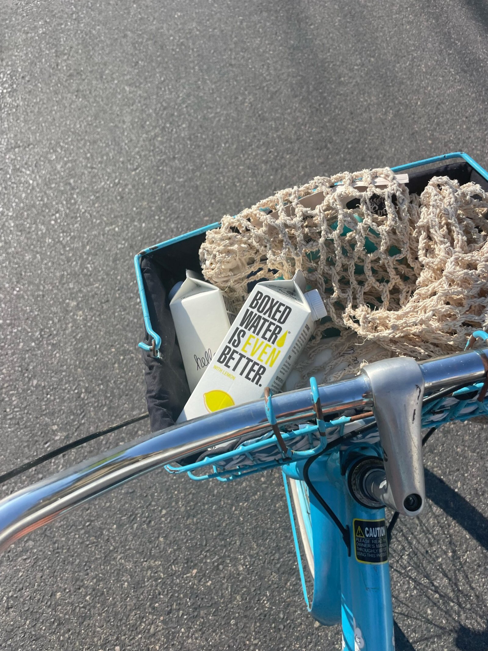 a blue bicycle with a basket full of items